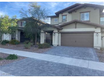 Two-story home with a neutral color palette, two-car garage, and desert landscaping at 330 Silva Pl, Henderson, NV 89011