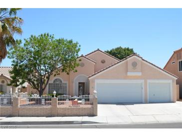 Charming single-story home boasts a well-manicured yard, two-car garage, and inviting curb appeal at 3519 W Red Coach Ave, North Las Vegas, NV 89031