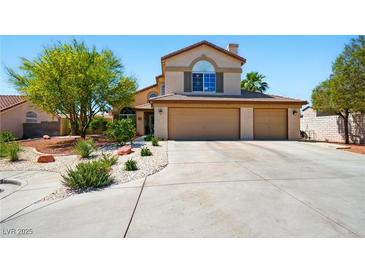Inviting two-story home featuring a spacious three-car garage and mature desert landscaping in front yard at 419 Alonzo Ct, Las Vegas, NV 89123