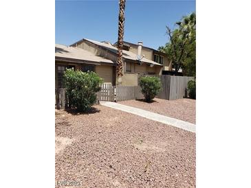 Inviting home with a neutral-toned exterior, a quaint, fenced yard, and easy to maintain landscaping at 4231 White Sands Ave, Las Vegas, NV 89121