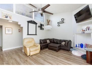Comfortable living room with leather furniture, a ceiling fan, and modern decorations on the wall at 45 N Lamb Blvd, Las Vegas, NV 89110