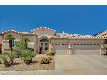 Charming single-story home with desert landscaping and a spacious three-car garage at 467 Beardsley Cir, Henderson, NV 89052