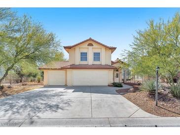 Two-story home with a three-car garage, tile roof, neutral paint, and desert landscaping at 5216 Desert Star Dr, Las Vegas, NV 89130