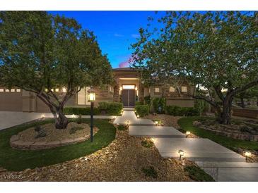 Inviting single-story home with stone accents, manicured landscaping, and pathway lighting at 9270 Valerie Elaine St, Las Vegas, NV 89139