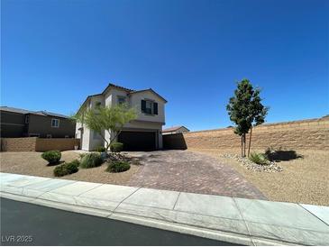 Charming two-story home features a two-car garage, brick driveway, and low-maintenance landscaping at 10148 Cluny Ave, Las Vegas, NV 89178