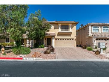 Charming two-story home with a well-maintained front yard and a paved driveway on a sunny day at 10908 Royal Highlands St, Las Vegas, NV 89141