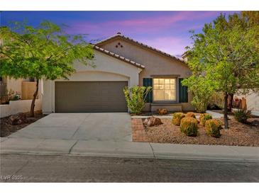 Charming single-story home with a two-car garage and well-manicured landscaping at 11764 Golden Moments Ave, Las Vegas, NV 89138