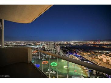 Expansive balcony view overlooking the city and Topgolf, with a glass railing, for seamless enjoyment at 135 E Harmon Ave # 2420, Las Vegas, NV 89109