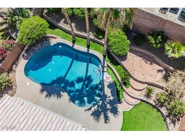 Aerial view of backyard pool featuring rock landscaping and ample patio space at 209 Camino Vista St, Henderson, NV 89012
