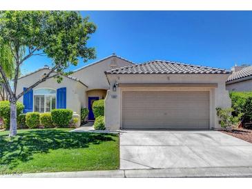 Charming single-story home featuring desert landscaping, blue shutters, and a two-car garage at 2687 Ivoryhill St, Las Vegas, NV 89135