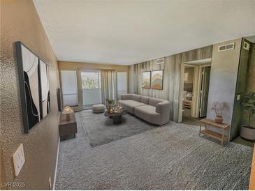 Cozy living room features neutral colors, balcony access and contemporary furnishings at 2867 Geary Pl # 3008, Las Vegas, NV 89109