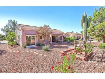 Inviting home featuring desert landscaping, mature trees, and a covered patio for outdoor enjoyment at 3013 Sungold Dr, Las Vegas, NV 89134