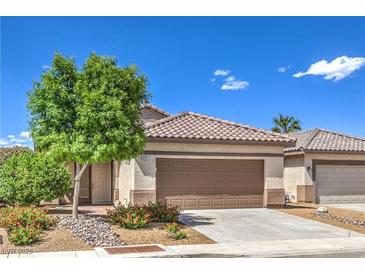 Charming single-story home featuring a well-maintained front yard, covered entry, and a two-car garage at 344 Golden Shore Dr, Las Vegas, NV 89123