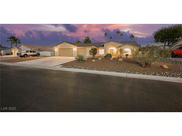 Charming single-story home with a well-maintained desert landscape and a two-car garage at sunset at 4016 Tyler William Ln, Las Vegas, NV 89130