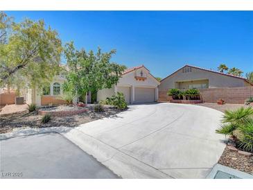 Charming one-story home with a two-car garage, desert landscaping, and a spacious driveway at 4197 Bottiglia Ave, Las Vegas, NV 89141