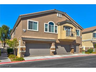 Beautiful two-story home with a two-car garage, stucco exterior, and private balcony in a well-kept neighborhood at 4779 Straight Flush Dr # 103, Las Vegas, NV 89122