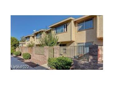 Charming townhome featuring a private fenced yard, mature landscaping, and a well-maintained facade at 6463 Big Pine Way, Las Vegas, NV 89108