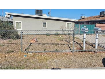 Modest single-story home featuring a fenced front yard and simple landscaping at 708 N 10Th St, Las Vegas, NV 89101
