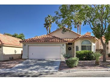 Charming single-story home featuring a terracotta tile roof, two-car garage, and well-maintained landscaping at 8109 Sunset Mill Dr, Las Vegas, NV 89128