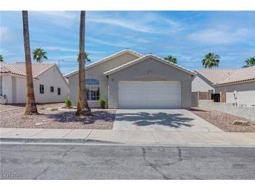 Charming single-story home with a two-car garage and xeriscaped front yard at 887 Cozy Valley St, Henderson, NV 89015