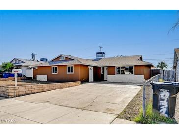 Charming single-story home with an expansive driveway, xeriscaping, and lush landscaping at 929 Center St, Henderson, NV 89015