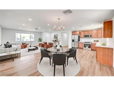 Bright living area featuring modern furnishings, light wood floors, and stainless kitchen appliances at 929 Center St, Henderson, NV 89015