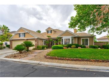Charming single-story home with a lush, green lawn, mature landscaping, and a welcoming facade at 1704 River Birch St, Las Vegas, NV 89117