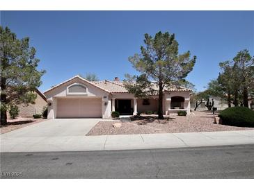 Charming single-story home featuring a two-car garage, tile roof, and desert landscaping at 2820 Bluff Point Dr, Las Vegas, NV 89134