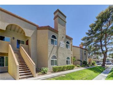View of the building's exterior featuring a staircase leading to the upper levels and well-maintained landscaping at 3145 E Flamingo Rd # 2080, Las Vegas, NV 89121