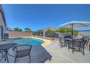 Relaxing backyard pool with mountain views and patio seating, perfect for outdoor entertaining at 4020 Driscoll Mountain St, Las Vegas, NV 89129