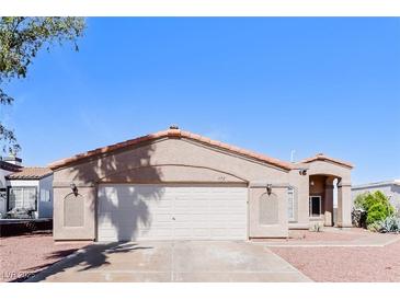Charming single-story home with a two-car garage, desert landscaping, and a well-maintained front yard at 472 Tiger Lily Way, Henderson, NV 89015