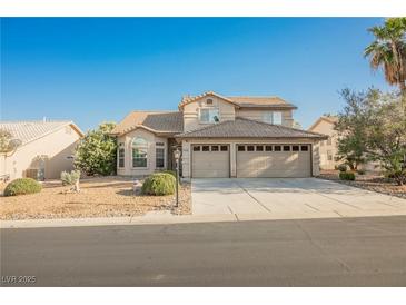 Two-story home featuring a two-car garage and desert landscaping at 5133 Burr Oak Dr, Las Vegas, NV 89130