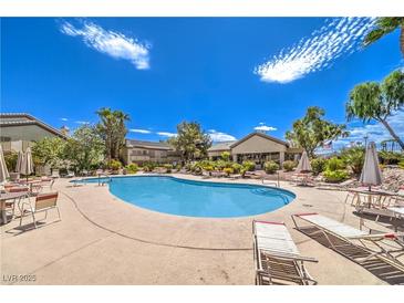 Enjoy the community pool with comfortable lounge chairs under the sunny blue sky at 5710 E Tropicana Ave # 1114, Las Vegas, NV 89122