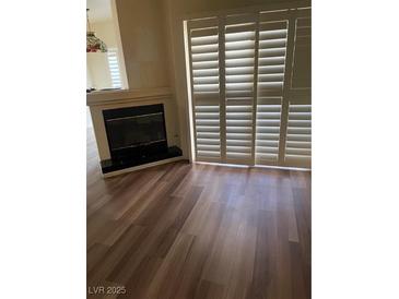 Bright living room features a fireplace and sliding door access to a patio at 6480 Annie Oakley Dr # 112, Las Vegas, NV 89120