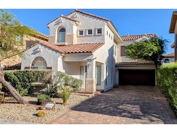 Charming two-story home with stucco siding, a red tile roof, and a brick driveway and desert landscaping at 8159 Base Camp Ave, Las Vegas, NV 89178