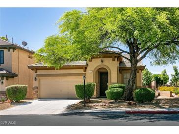 Charming single-story home with a well-manicured lawn and mature shade tree in a suburban neighborhood at 9025 Rusty Rifle Ave, Las Vegas, NV 89143