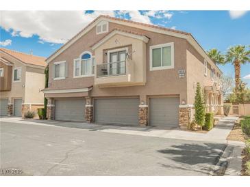 Inviting stucco townhome with three-car garage and charming balcony perfect for relaxing at 9490 Thunder Sky St # 102, Las Vegas, NV 89178