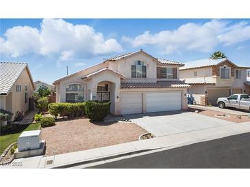Charming two-story home with a well-maintained yard, two-car garage, and classic desert landscaping at 9785 Turtle Head Ct, Las Vegas, NV 89117