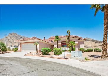 Charming single-story home with a tile roof, desert landscaping, and an attached two-car garage at 10720 Bennington Ct, Las Vegas, NV 89134