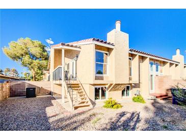 Charming two-story home with a stucco exterior, desert landscaping, and a welcoming entrance at 1308 Capri Dr # D, Boulder City, NV 89005