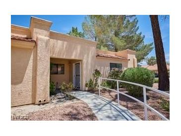 Single-story home featuring a stucco exterior, red tile roof, and a paved walkway leading to the front door at 2851 S Valley View Blvd # 1199, Las Vegas, NV 89102