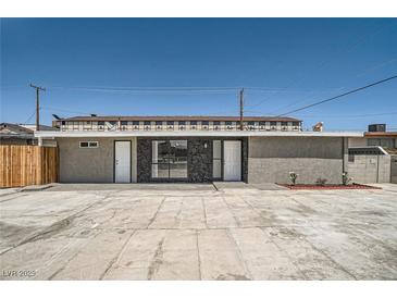 Home with modern exterior features a spacious parking area and decorative rock accents at 4558 Sheppard Dr, Las Vegas, NV 89122