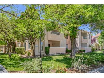 Inviting condo complex featuring lush landscaping and trees, creating a serene atmosphere at 4843 S Torrey Pines Dr # 101, Las Vegas, NV 89103