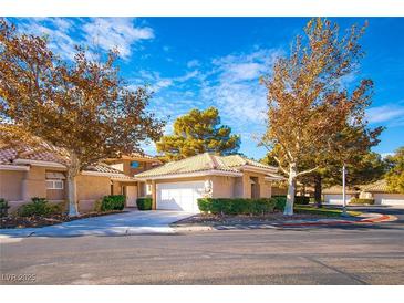 Inviting single-story home boasts mature trees, a two-car garage, and meticulously maintained landscaping at 4911 Mount Pleasant Ln, Las Vegas, NV 89113