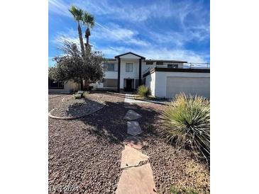 Inviting home featuring drought-resistant landscaping, desert flora, and a stone walkway leading to the entrance at 5243 Sunnywood Dr, Las Vegas, NV 89120