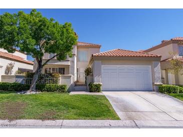 Charming two-story home with red tile roof, manicured lawn, mature tree and gated courtyard at 8196 Horseshoe Bend Ln, Las Vegas, NV 89113