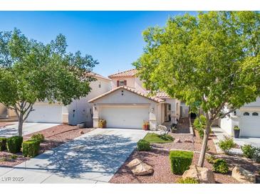 Charming two-story home features a well-maintained yard, a two-car garage, and desert landscaping at 8884 Perfect Diamond Ct, Las Vegas, NV 89129