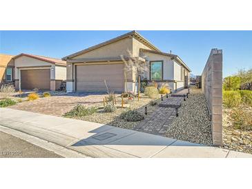 Charming home featuring a brick driveway, two-car garage, and desert landscaping at 9698 Pacific Pine St, Las Vegas, NV 89143