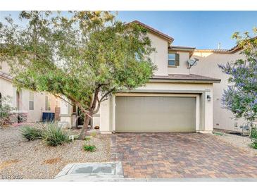 Charming two-story home with a two car garage, desert landscaping and brick paver driveway at 9846 Sunriver Meadows Ave, Las Vegas, NV 89148