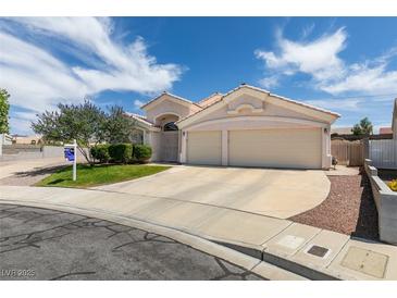 Charming single-story home with a well-manicured lawn, desert landscaping, and two-car garage at 1017 Guided Dancer Ave, Henderson, NV 89015